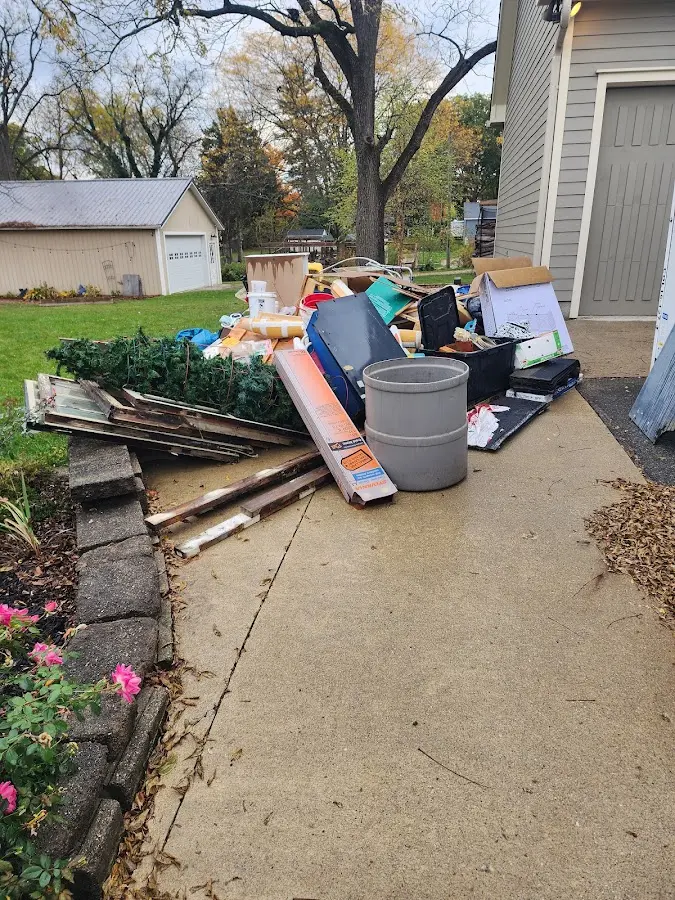 Dumpster being loaded with debris for Estate Cleanout Dumpster Rental in Roxboro